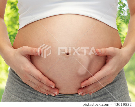 close up of pregnant belly with baby footprint close up of pregnant belly with baby footprint 43619822