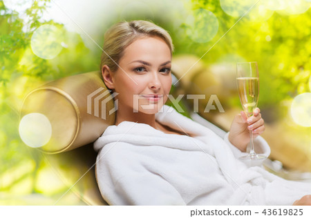 beautiful young woman drinking champagne at spa beautiful young woman drinking champagne at spa 43619825
