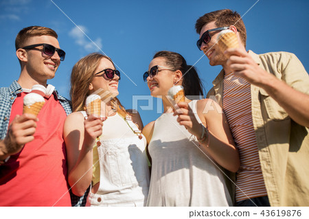 group of smiling friends with ice cream outdoors group of smiling friends with ice cream outdoors 43619876