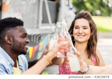 friends clinking bottles with drinks at food truck 43619878