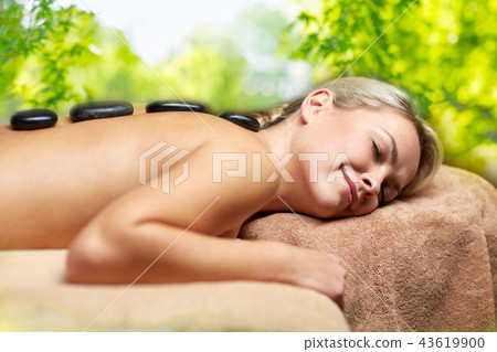 close up of woman having hot stone massage in spa close up of woman having hot stone massage in spa 43619900