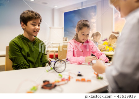 happy children building robots at robotics school happy children building robots at robotics school 43619939