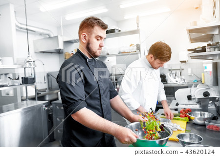 chef and cook cooking food at restaurant kitchen chef and cook cooking food at restaurant kitchen 43620124