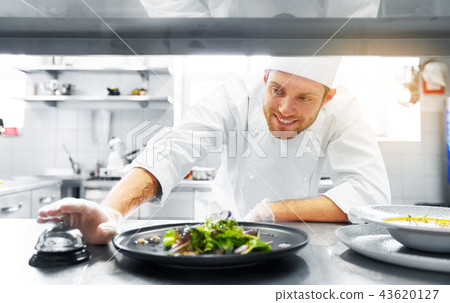 happy male chef cooking food at restaurant kitchen happy male chef cooking food at restaurant kitchen 43620127