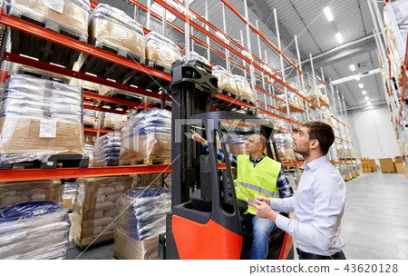 worker and businessman with tablet pc at warehouse worker and businessman with tablet pc at warehouse 43620128