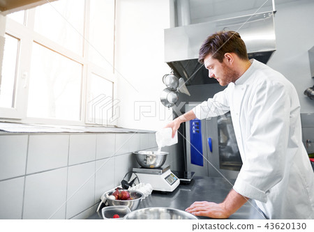 happy male chef cooking food at restaurant kitchen happy male chef cooking food at restaurant kitchen 43620130