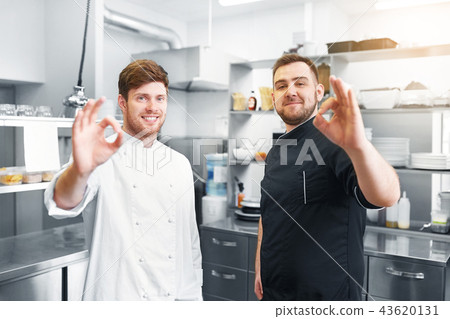 happy chefs at restaurant kitchen showing ok sign 43620131