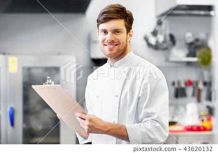 chef with clipboard doing inventory at restaurant chef with clipboard doing inventory at restaurant 43620132