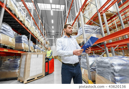 businessman and worker on forklift at warehouse businessman and worker on forklift at warehouse 43620136