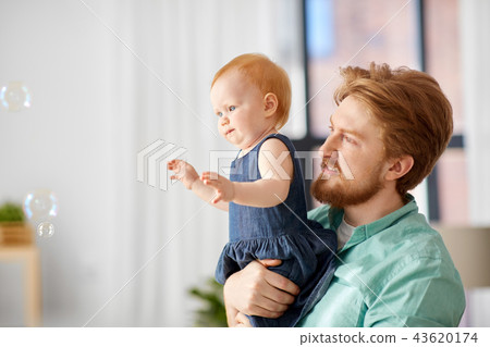 father and baby daughter with soap bubbles at home 43620174