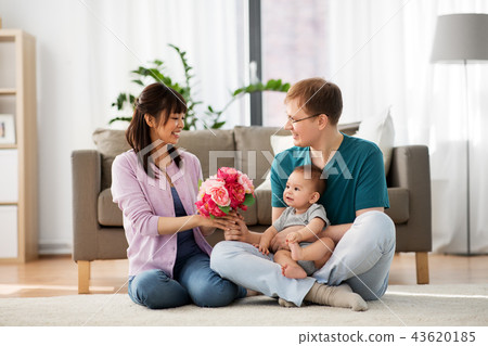 happy family with flowers and baby boy at home happy family with flowers and baby boy at home 43620185