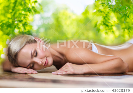 young woman lying on hammam table in turkish bath young woman lying on hammam table in turkish bath 43620379