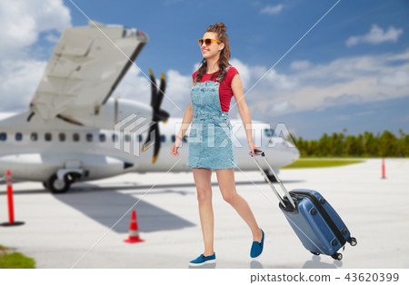 teenage girl with travel bag over airfield 43620399