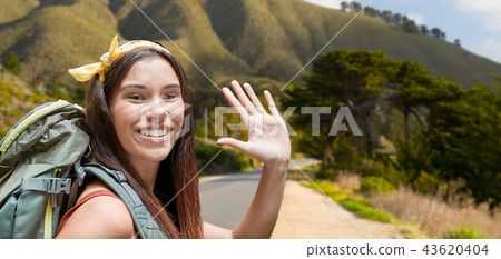 smiling woman with backpack on big sur hills 43620404