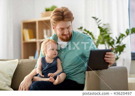 father and baby daughter with tablet pc at home 43620497