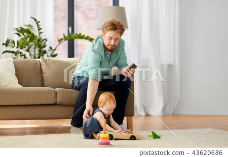 father and baby playing with toy blocks at home 43620686