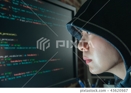 female hacker staring at the monitor seriously female hacker staring at the monitor seriously 43620987