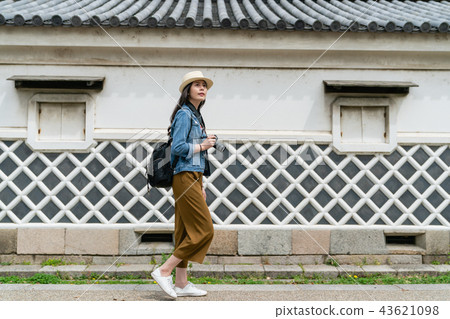 female sightseeing and holding camera 43621098