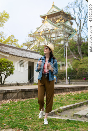 female visitor using her phone while sightseeing 43621100