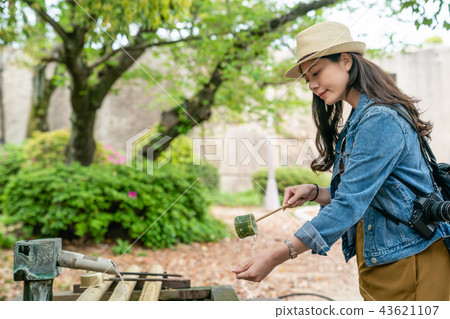 traveler doing hands washing to purify soul 43621107