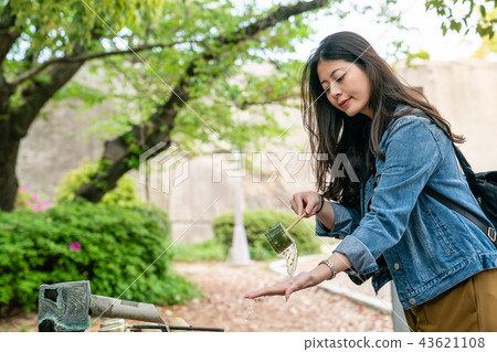 girl smiling and taking ladle to wash hands 43621108