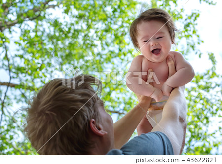 Father holding up his happy baby boy Father holding up his happy baby boy 43622821