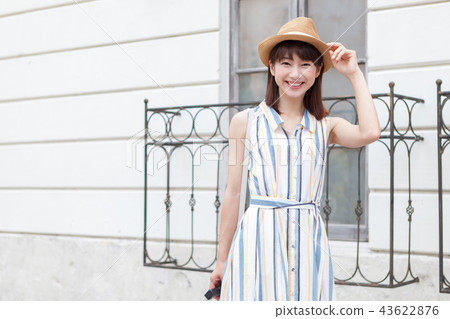 Young woman walking in the town on a trip while traveling 43622876