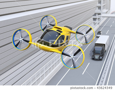Image of yellow drone taxi flying above freeway. Image of yellow drone taxi flying above freeway. 43624349