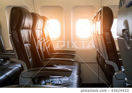 Empty seats and window inside an aircraft Empty seats and window inside an aircraft 43624420
