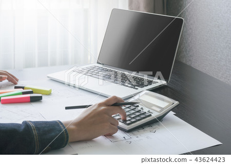 female accountant consider on calculator in office female accountant consider on calculator in office 43624423