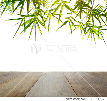 wooden table top with green bamboo leaves wooden table top with green bamboo leaves 43624437
