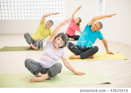 4 healthy Japanese senior men and women playing yoga 4 healthy Japanese senior men and women playing yoga 43625619