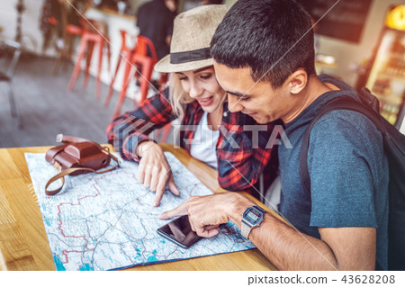Smiling couple planning route with city map Smiling couple planning route with city map 43628208