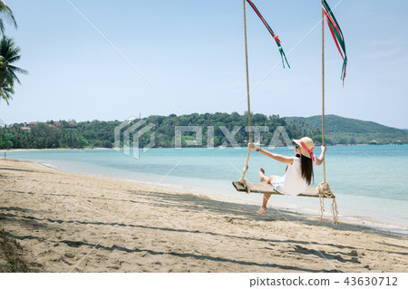 Woman on swing in beach 43630712