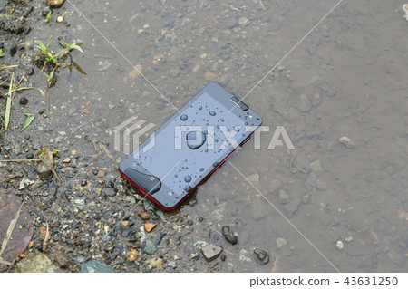 Smartphone fell in a puddle Smartphone fell in a puddle 43631250