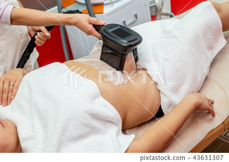 Woman getting cryolipolysis fat treatment Woman getting cryolipolysis fat treatment 43631307