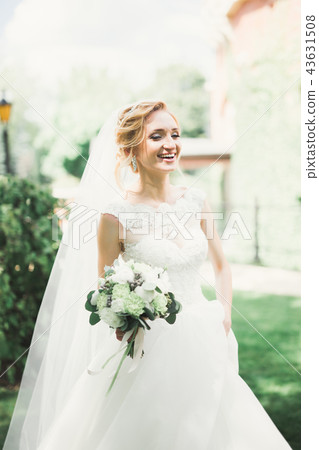 Bride holding big and beautiful wedding bouquet with flowers 43631508