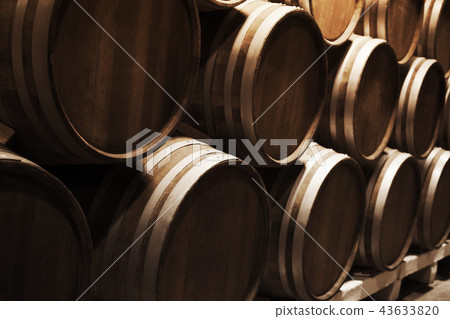 Round wooden barrels in dark winery 43633820