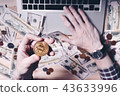 Businessman holding bitcoin 43633996