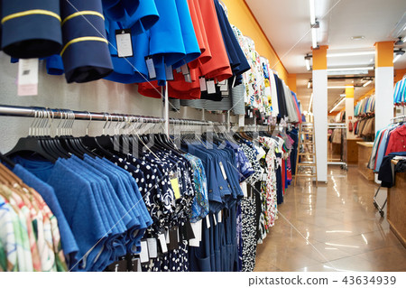 Different clothes on hangers in store 43634939