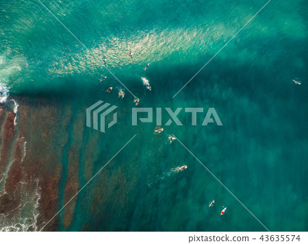 Aerial view with surfers and wave in blue ocean 43635574