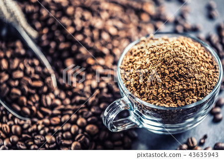 Granules of instant coffee in glass cupfrom beans. Granules of instant coffee in glass cupfrom beans. 43635943