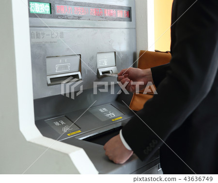 Men using ATM 43636749