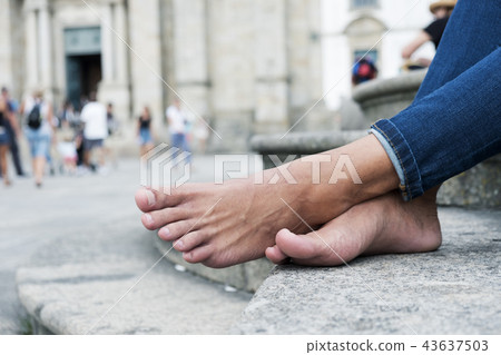 man resting barefoot on the street man resting barefoot on the street 43637503