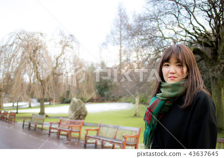 A beautiful Asian lady in a park. A beautiful Asian lady in a park. 43637645
