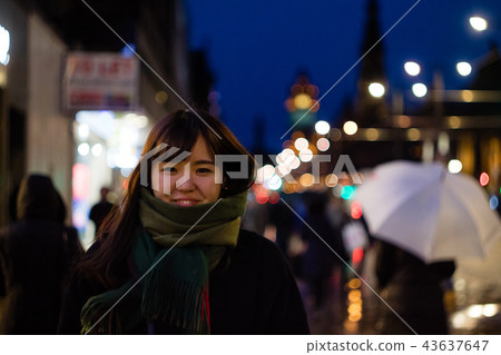 A beautiful Asian lady in the city at night A beautiful Asian lady in the city at night 43637647