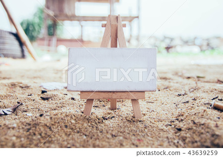 conceptual image white canvas and wooden easel ove 43639259