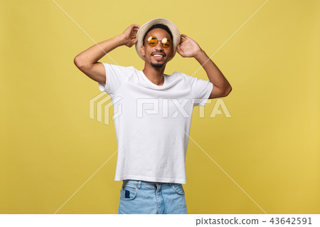 Close up portrait of young afro american shocked tourist , holding his eyewear, wearing tourist 43642591