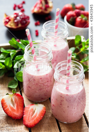 Strawberry pomegranate smoothies on wooden tray 43643945