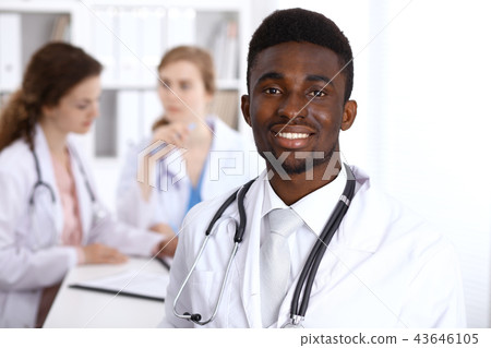 Happy african american male doctor with medical staff at the hospital. Medicine concept Happy african american male doctor with medical staff at the hospital. Medicine concept 43646105
